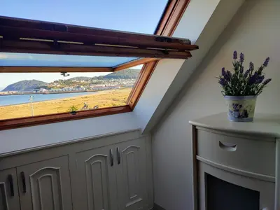 a room with a window with a view of the beach at Perla del Cantábrico in Vivero