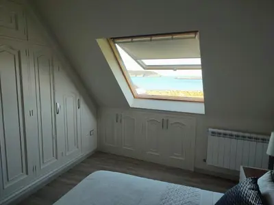 a attic room with a skylight and a window at Perla del Cantábrico in Vivero