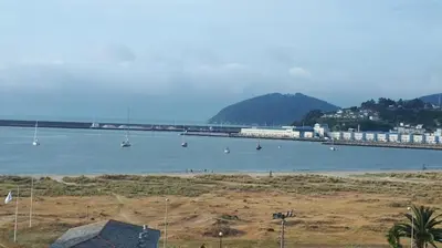 a train crossing a bridge over a body of water at Perla del Cantábrico in Vivero