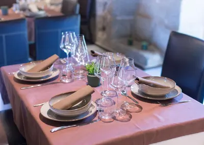 a table with plates and wine glasses on a table at Reitoral de Parada in Parada del Sil