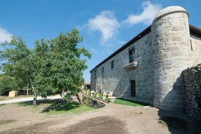 a stone building with a tree next to it at Reitoral de Parada in Parada del Sil