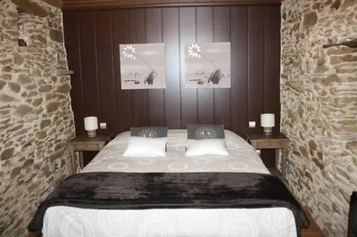 a bedroom with a bed with three pictures on the wall at Alojamiento Luz de Hadas in Sampil