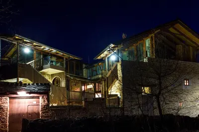 a large house with a garage at night at Alojamiento Luz de Hadas in Sampil