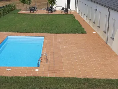a swimming pool in the middle of a yard at Hosteria de Gonzar in Gonzar