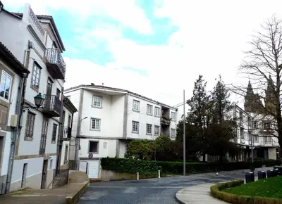an empty street with white buildings on the side at Blanco Apartamentos Turísticos in Santiago de Compostela