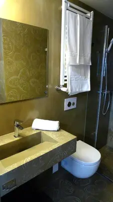 a bathroom with a sink and a toilet and a mirror at Blanco Apartamentos Turísticos in Santiago de Compostela