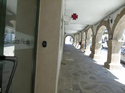 a hallway of an arcade with a star on the wall at Casa San Nicolás in Portomarin