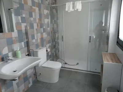 a bathroom with a toilet and a sink and a shower at Pension Xacobeo Lavacolla in Lavacolla