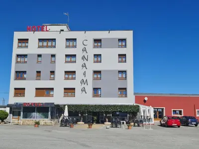a white building with a sign on it at Hotel Canaima Bruma 1,5 k Camino in O Mesón Do Vento