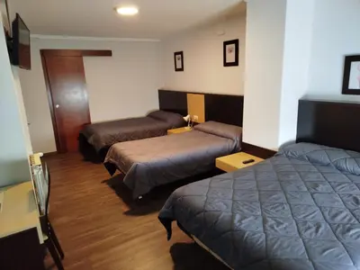 a room with two beds in a hotel room at Hotel Canaima Bruma 1,5 k Camino in O Mesón Do Vento
