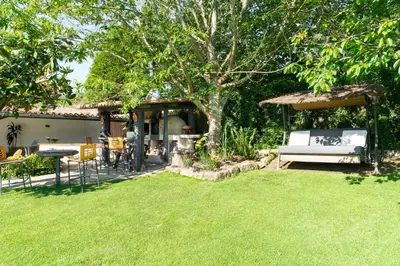 a garden with a bench and a table and a tree at VILLA GUIMIL - GALICIA PLAYA in Villarmayor