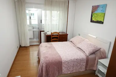 a bedroom with a bed and a table and a desk at Céntrico exterior amplio 110 m. in Santiago de Compostela