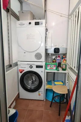 a washer and dryer in a tiny house at Céntrico exterior amplio 110 m. in Santiago de Compostela