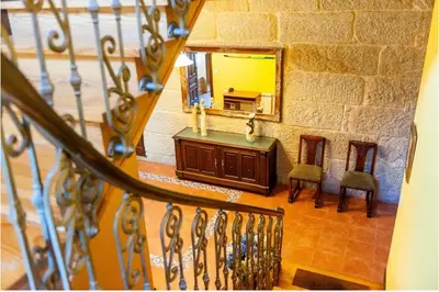 a staircase with a mirror and a vanity and chairs at Spacious House with Pool in Carballedo in Carballedo