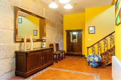 a hallway with yellow walls and a mirror at Spacious House with Pool in Carballedo in Carballedo