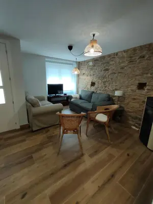 a living room with a couch and a table at Casa Luis in Arzúa