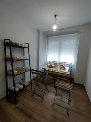 a room with a table and chairs and a window at Casa Luis in Arzúa