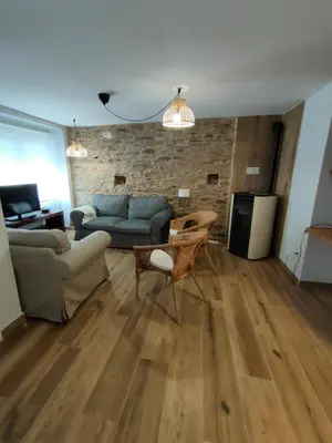 a living room with a couch and a table at Casa Luis in Arzúa