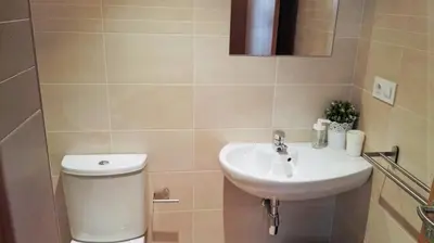 a bathroom with a toilet and a sink at Apartagal-San Miguel Barreiros in Barreiros