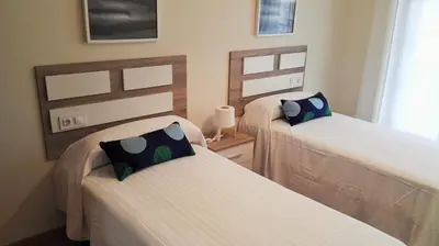 two beds in a room with two at Apartagal-San Miguel Barreiros in Barreiros