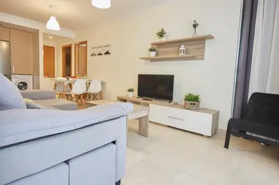 a living room with a couch and a tv in it at Apartagal-San Miguel Barreiros in Barreiros
