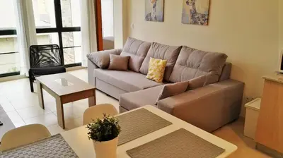 a living room with a couch and a table at Apartagal-San Miguel Barreiros in Barreiros
