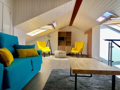 a living room with a blue couch and yellow chairs at Apartamentos Turísticos Casa Dina in Rinlo