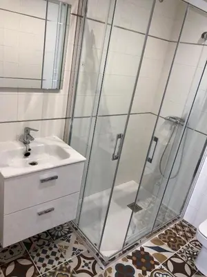 a bathroom with a shower and a sink at Apartamentos Turísticos Casa Dina in Rinlo