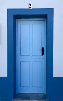 a door in a blue wall with the number two at Apartamentos Turísticos Casa Dina in Rinlo