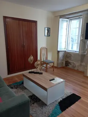 a living room with a couch and a coffee table at Apartamento en el casco histórico in Santiago de Compostela