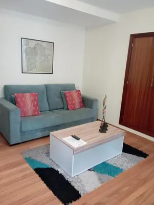 a living room with a couch and a coffee table at Apartamento en el casco histórico in Santiago de Compostela
