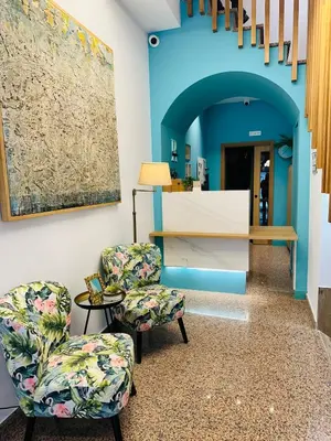 a hallway with two chairs and a table at HOTEL LOTUS in Caldas de Reis