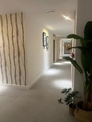 a hallway with a wall mural of trees on the wall at HOTEL LOTUS in Caldas de Reis