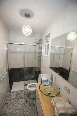 a bathroom with a shower and a toilet and a sink at Duplex Familiar in Ribadavia