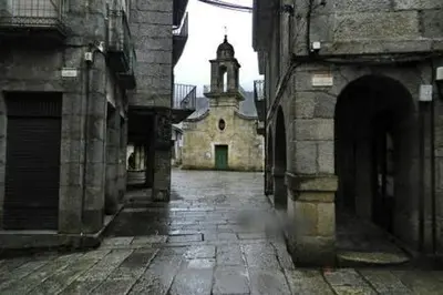 an old building with a tower and a church at Duplex Familiar in Ribadavia