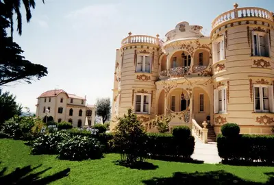 a large building with a lawn in front of it at Hotel Palacete Peñalba in Castropol
