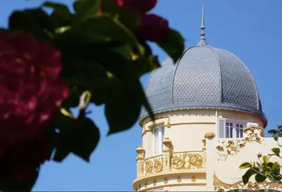 a building with a turret with a cross on it at Hotel Palacete Peñalba in Castropol