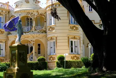a statue in front of a large building at Hotel Palacete Peñalba in Castropol
