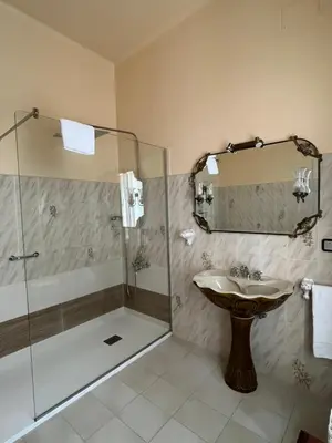 a bathroom with a sink and a shower at Hotel Palacete Peñalba in Castropol