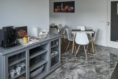 a kitchen with a counter and a table and a table at Xabarin Rooms in Abadín