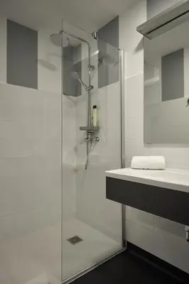 a white bathroom with a shower and a sink at Xabarin Rooms in Abadín