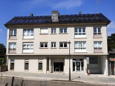 a building with solar panels on top of it at Xabarin Rooms in Abadín