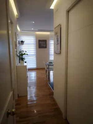 a hallway with a table and a dining room at Burgas Termal in Ourense