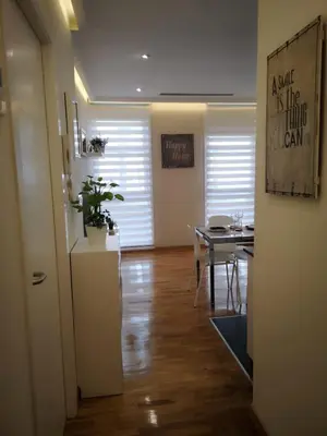 a kitchen and a dining room with a table at Burgas Termal in Ourense