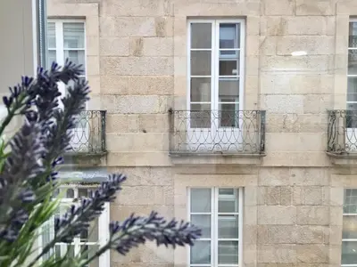 a brick building with windows and balconies at Burgas Termal in Ourense