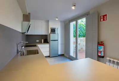 a kitchen with a sink and a refrigerator at APARTAMENTOS BARCELLA TAPIA in Tapia de Casariego