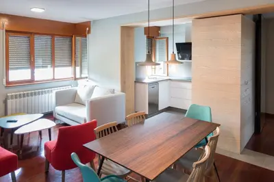 a kitchen and dining room with a table and chairs at APARTAMENTOS BARCELLA TAPIA in Tapia de Casariego