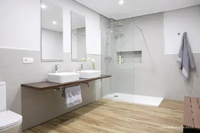 a bathroom with two sinks and a shower at Casa Borlas in Vilamelle