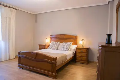 a bedroom with a bed with two night stands and two lamps at Casa Borlas in Vilamelle