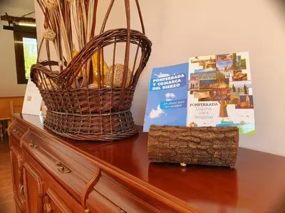 a basket and a book sitting on top of a dresser at Casa Carreira Bierzo in Ponferrada